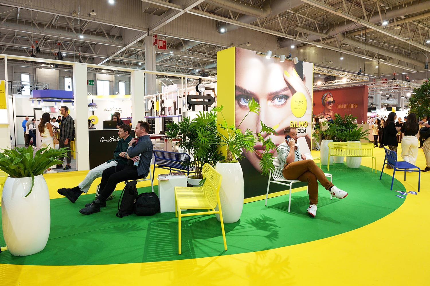 People taking a break among stands at SILMO Paris