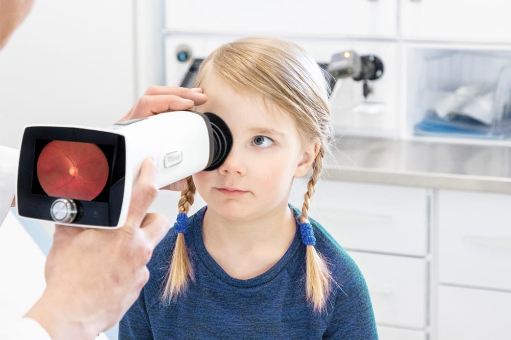child having vision tested with Aurora IQ