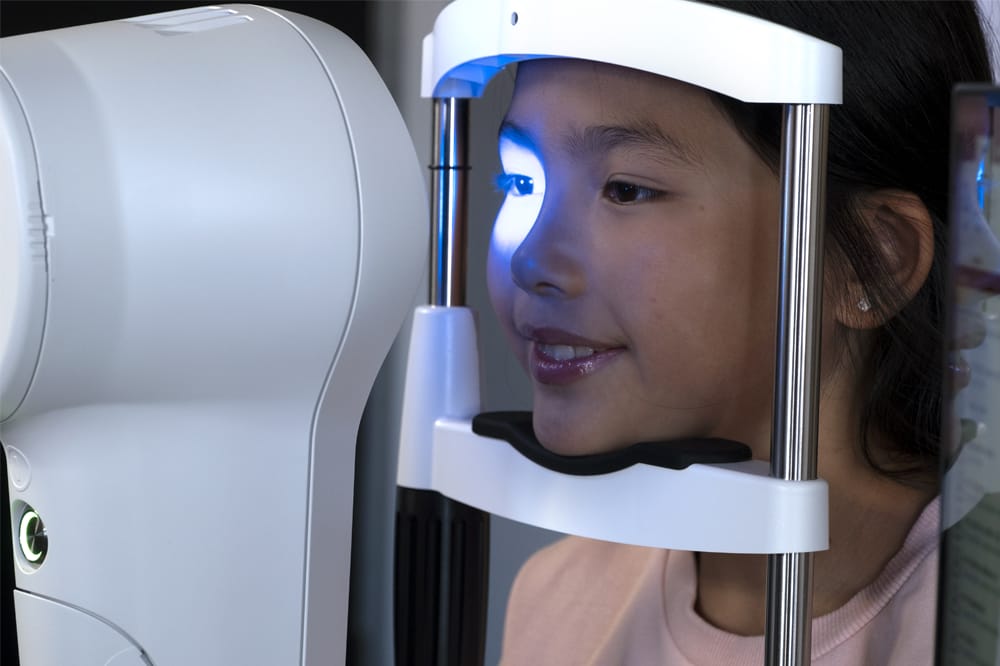 child being scanned in Medmont Meridia Advanced Topographer