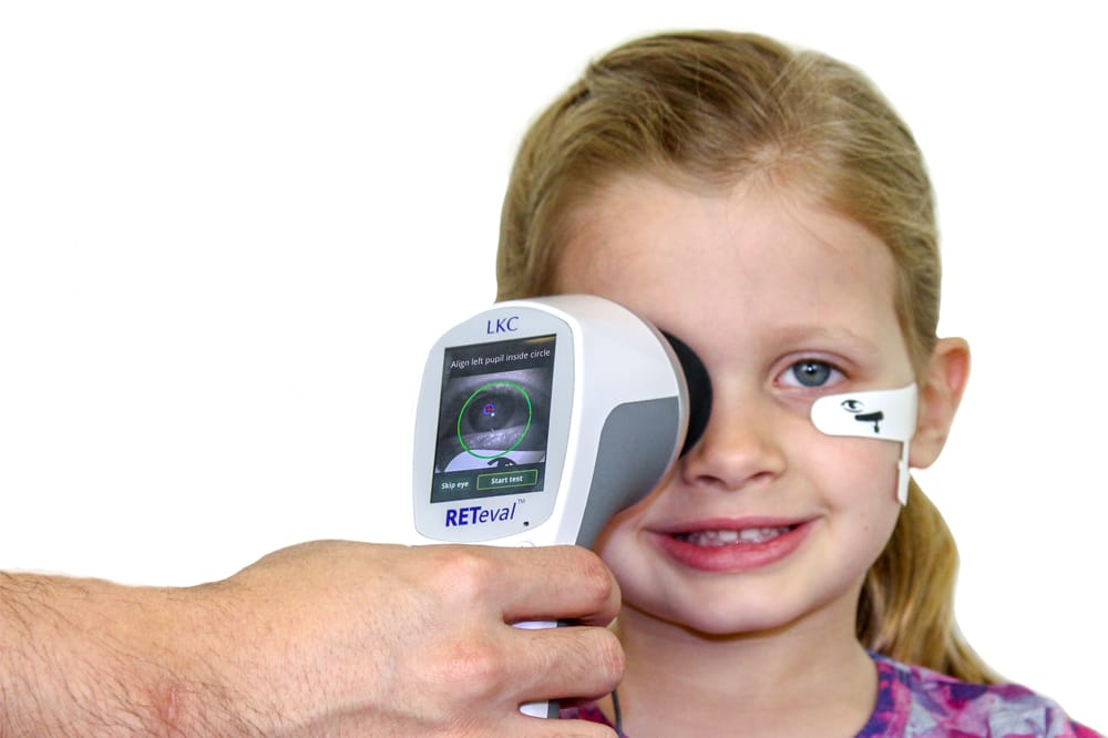 child having vision tested with Reteval