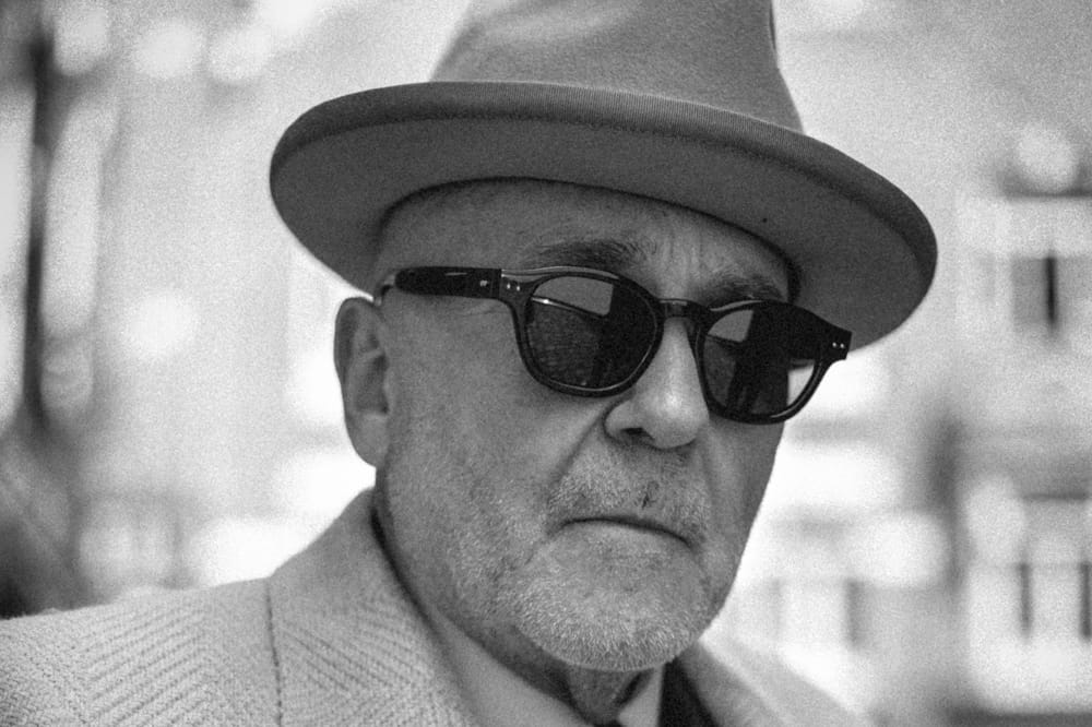 Black series by Linda Farrow. Image shows man wearing sunglasses