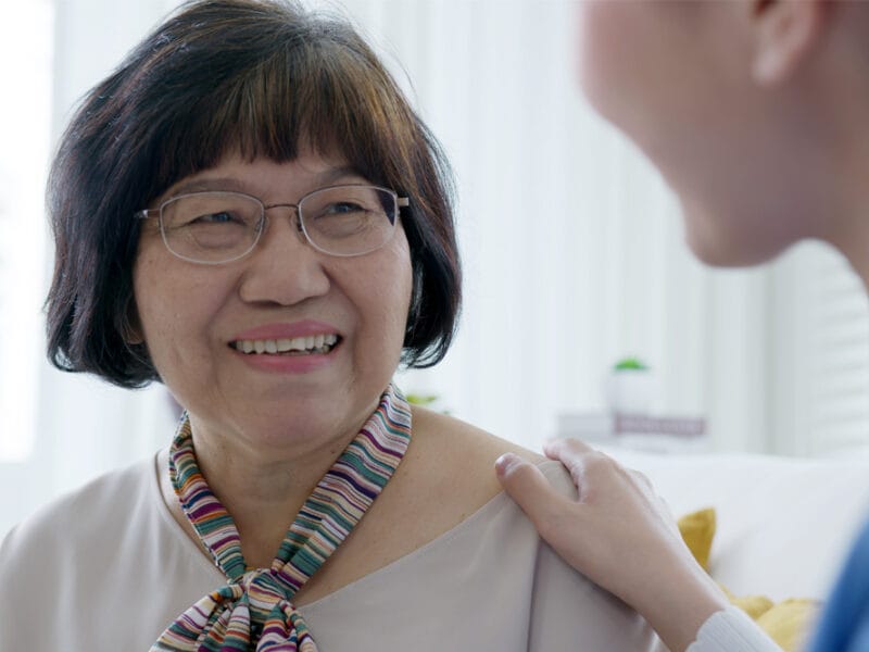 Image shows an older woman being comforted by a health professional after her glaucoma diagnosis.