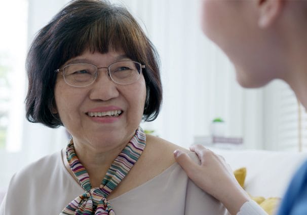 Image shows an older woman being comforted by a health professional after her glaucoma diagnosis.