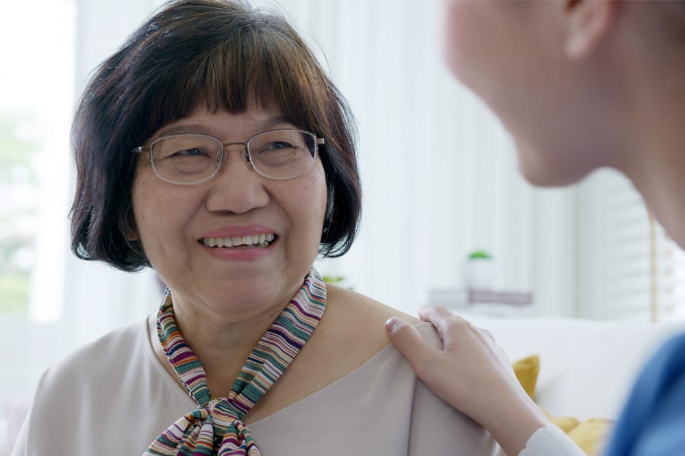 Image shows an older woman being comforted by a health professional after her glaucoma diagnosis.