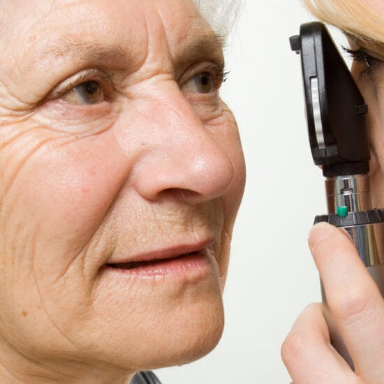 Eye health professional checking a woman's eyes for glaucoma.
