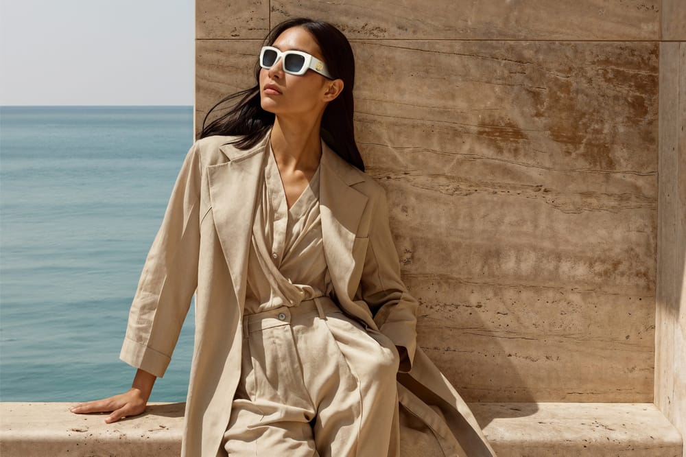 woman wearing INVU Fashionista Edition against the backdrop of the ocean