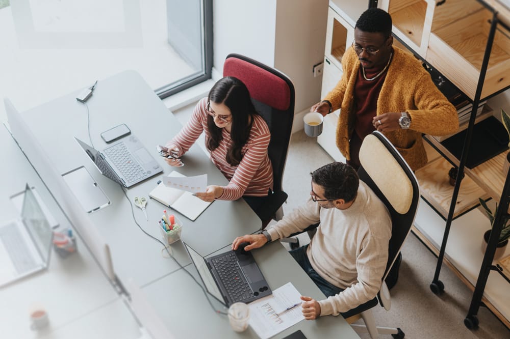 Image shows office space, people wearing glasses with occupational lenses