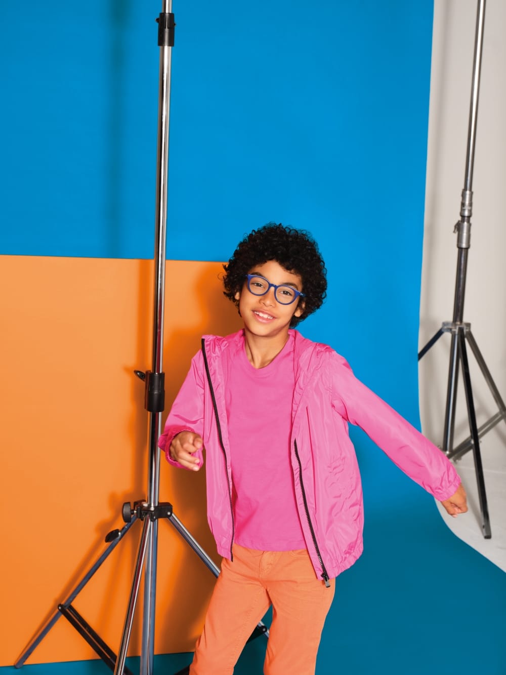 child against colourful background wearing polaroid eyewear