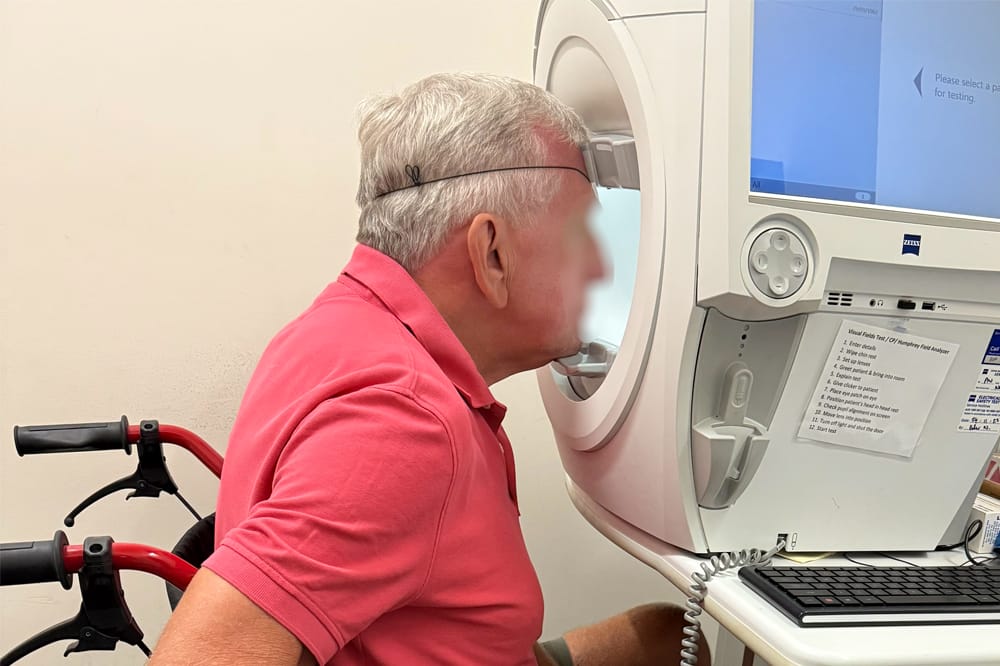 Patient in a wheelchair undergoing visual field testing