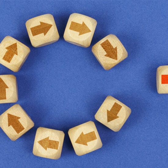 Graphic of blocks with arrows - one has left the circle and is going in a different direction, indicating change with career dissatisfaction.