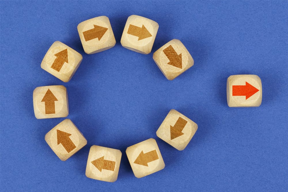 Graphic of blocks with arrows - one has left the circle and is going in a different direction, indicating change with career dissatisfaction.