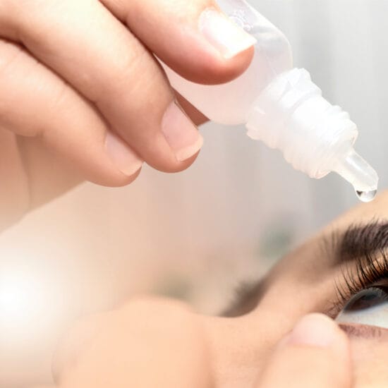 woman putting in drops as part of dry eye disease eye care