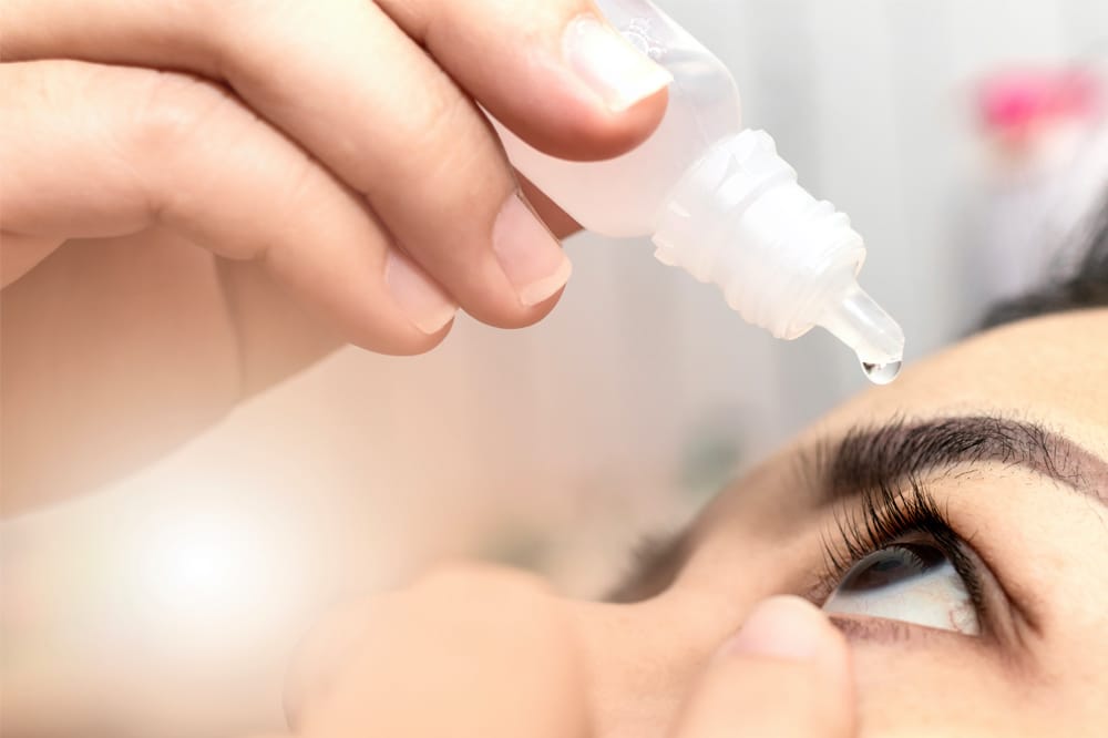 woman putting in drops as part of dry eye disease eye care