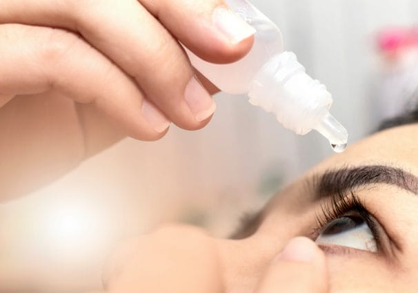 woman putting in drops as part of dry eye disease eye care