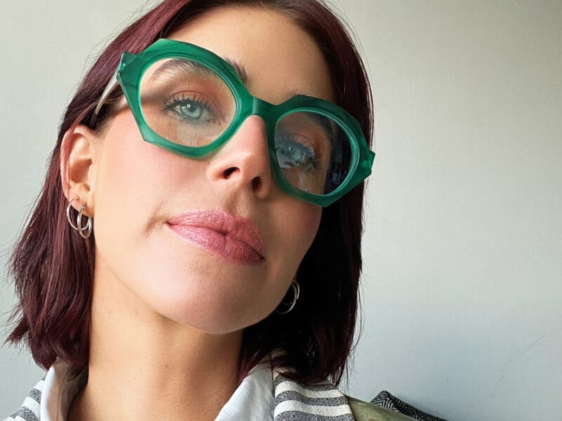 woman wearing green kirk and kirk frames