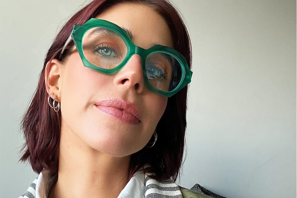 woman wearing green kirk and kirk frames