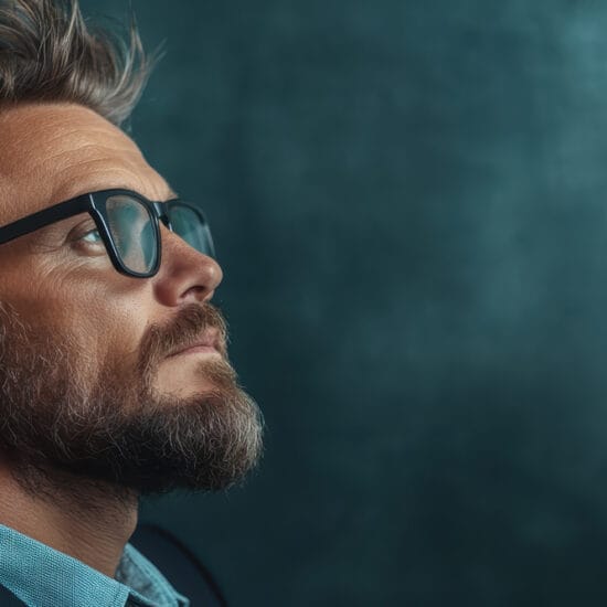 Man in glasses looking into distance - cover of the macular disease guest editorial.