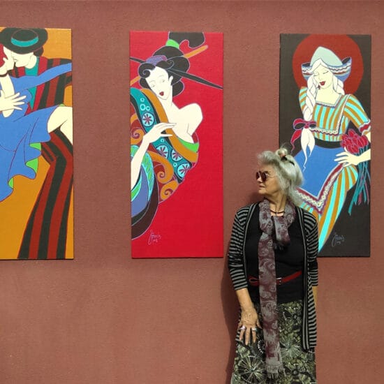 Jan Francis standing against her artworks