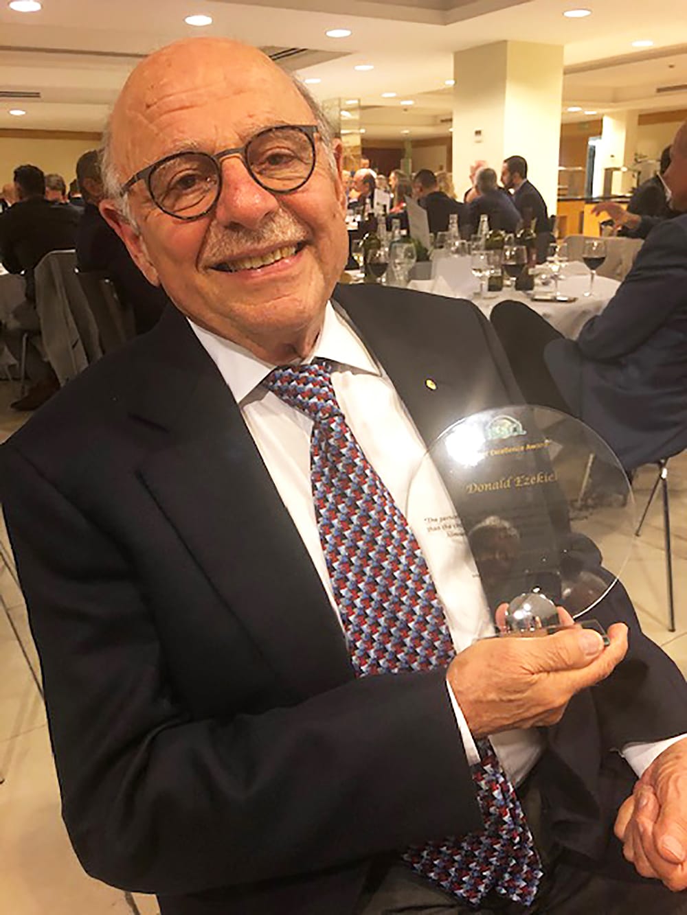 Donald Ezekiel being honoured for his involvement in gas permeable scleral lenses by the International Summit of Speciality Contact Lenses in Italy in 2019.