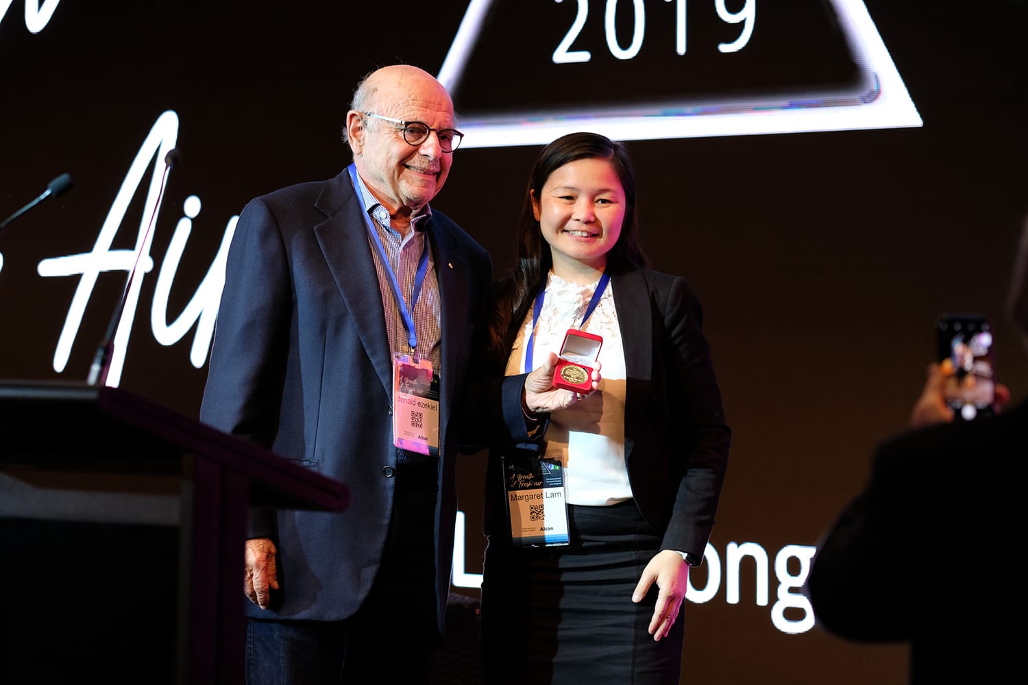 Dr Ezekiel being presented with the Kenneth W. Bell Medal for his distinguished contribution to the field of cornea and contact lenses by Dr Margaret Lam in 2019.