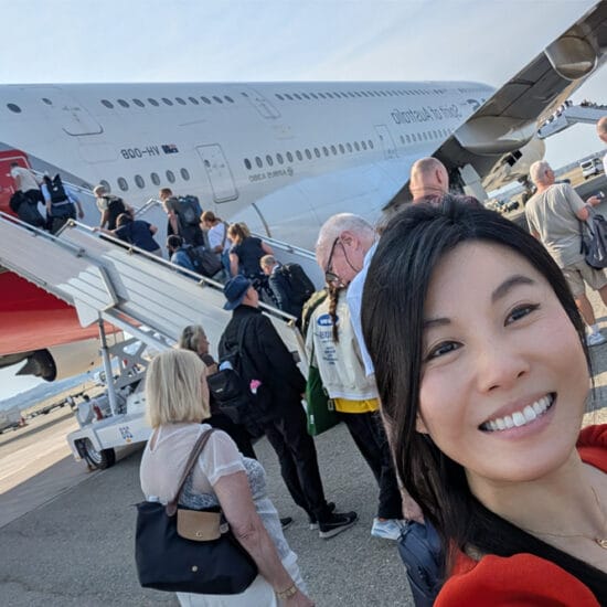 Dr Tanya Trinh takes a selfie in front of the Qantas plane