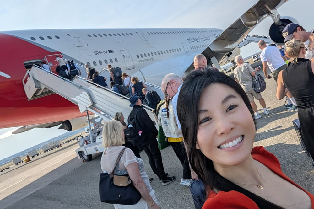 Dr Tanya Trinh takes a selfie in front of the Qantas plane