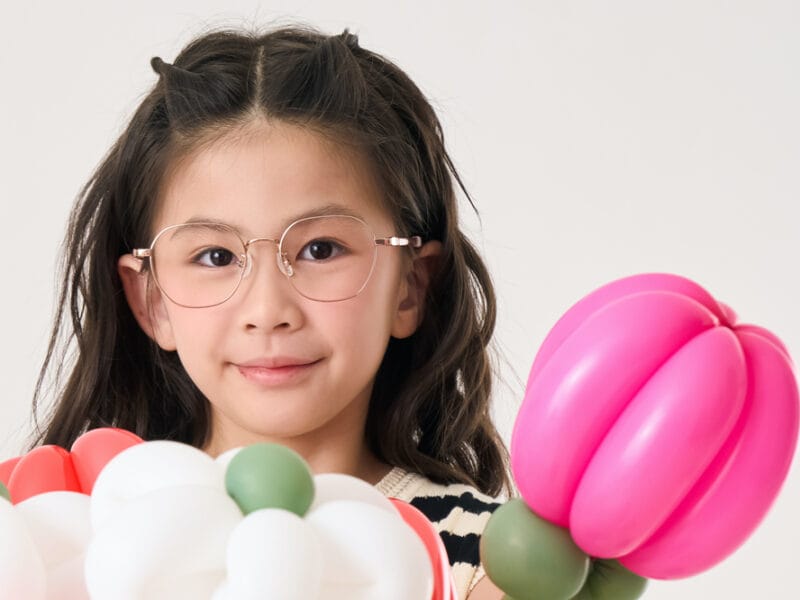 Girl with balloons wearing Lipo eyewear