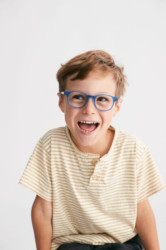 Kid wearing Augie eyewear frames, which are suited for myopia management