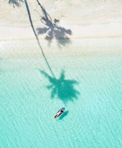 Person swimming on secluded beach, photography by RipCurl