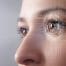 Close up of woman's eye with a diagram over it, representing macular disease research