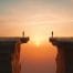 two people sanding on opposite sides of a cliff representing business divorce