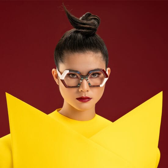 Ultra limited glasses on woman wearing yellow geometric top